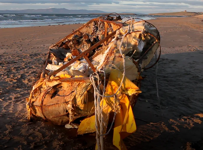 photo of boat washed up on a beach